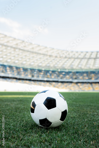 soccer ball on grassy football pitch at stadium