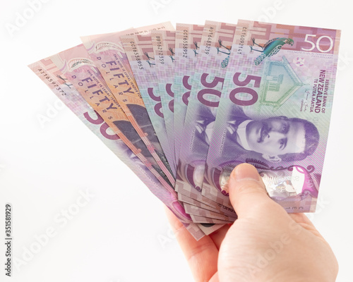 Closeup New Zealand 50 Dollars Banknotes on white background, NZ currency, Banknotes in handheld fanned out