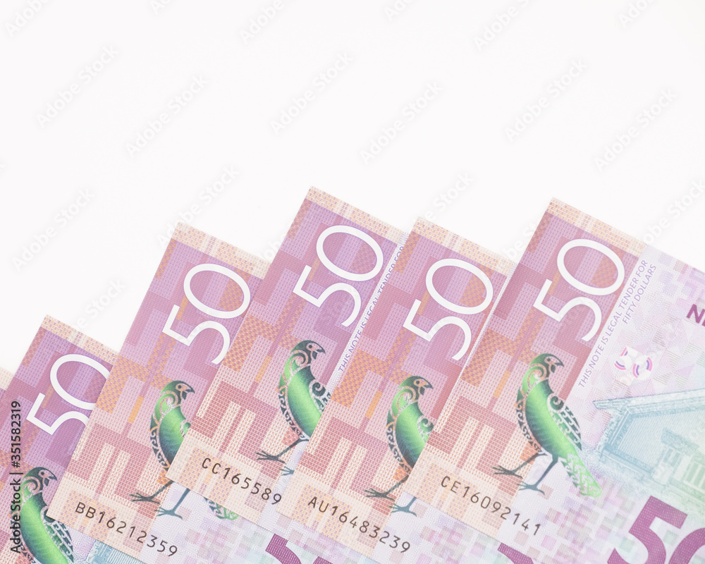 Closeup Stack of New Zealand 50$ Dollar banknotes on white background with copy space for text Closeup Stack of New Zealand 50$ Dollar banknotes on white background with copy space for text