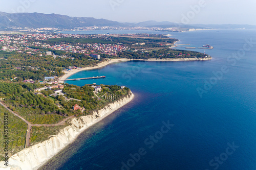 The Resort Of Gelendzhik. the area of Blue Bay. A small Bay with a beach and a sea pier. In the background the Gelendzhik Bay and the Markotkh mountain range