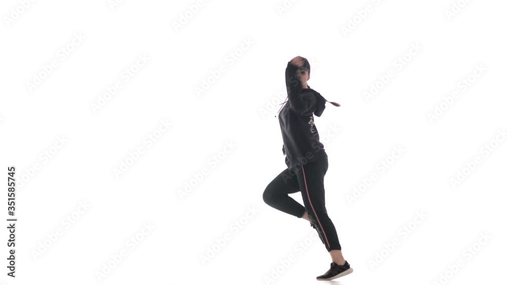 young beautiful girl dancer in tracksuit and baseball cap dancing hip hop, contemporary, modern street dance, isolated young beautiful girl dancer in tracksuit and baseball cap dancing hip hop, contemporary, modern street dance, isolated