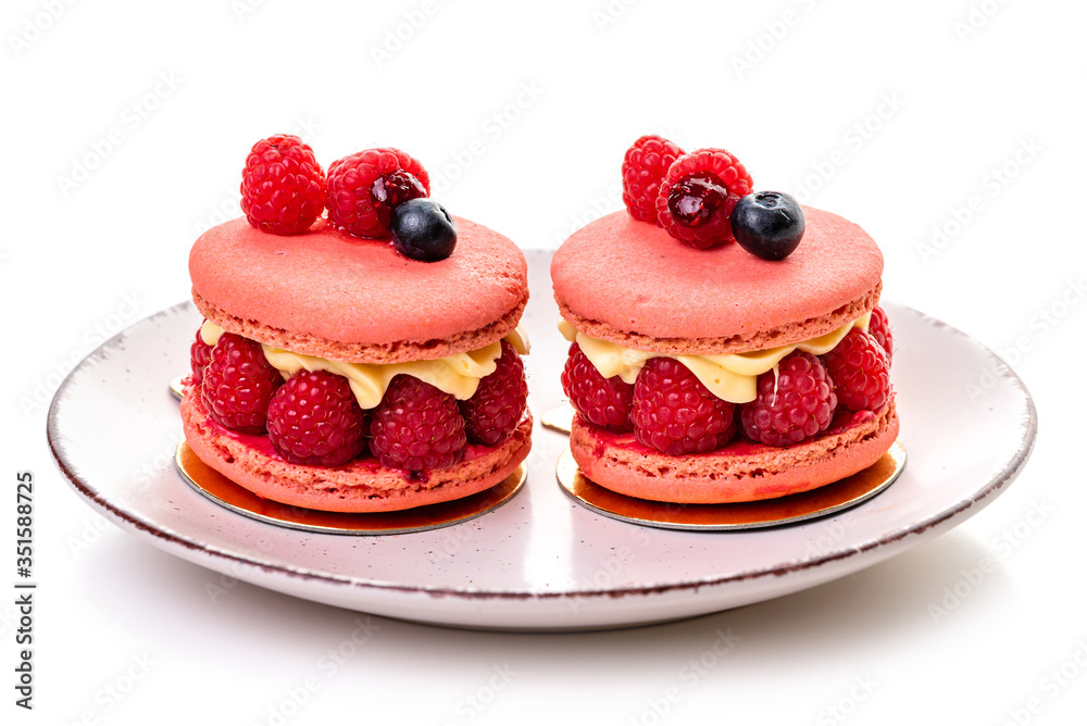 Raspberry macaron. Two cakes with raspberries and cream on a plate on a white background, isolate