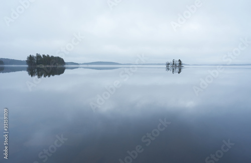 Fotografie Still gray lake scenery in the spring morning