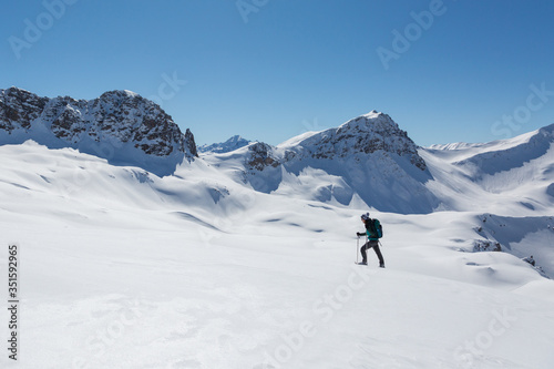 women with snowshoes walking in snowy winter landscape in Schanfigg