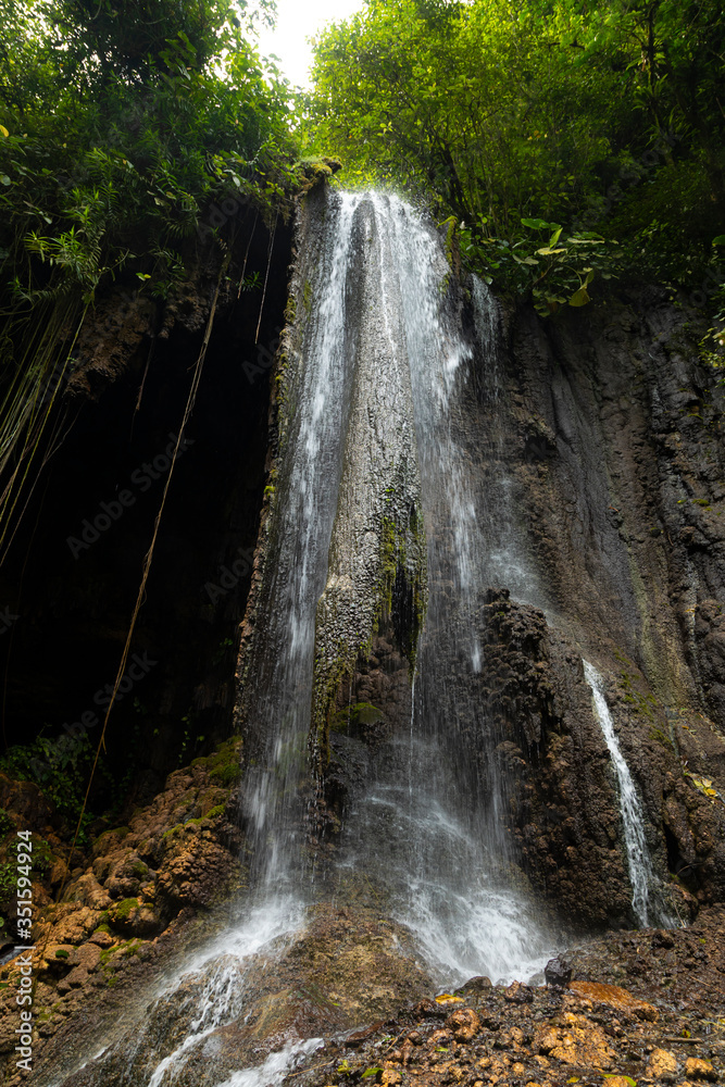 Fototapeta premium View of the fresh, noisy and intense water in Tumpak Sewu Waterfall, in East Java, Indonesia.