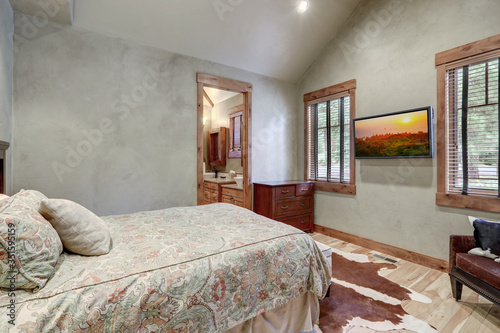 Bedroom interior with grey plaster venetian wall finish and cow skin on the floor. Luxury home,