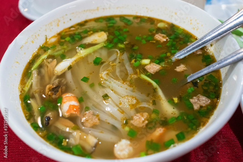 Classical Vietnamese soup pho with rice noodles and fresh seafood with green onion tasty