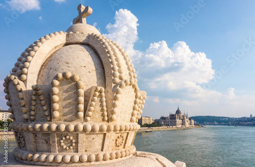 Photography Budapest, Hungary - September 01, 2019: Crown decoration on Margaret Bridge in Budapest and a panorama of the Danube River and the Hungarian Parliament building