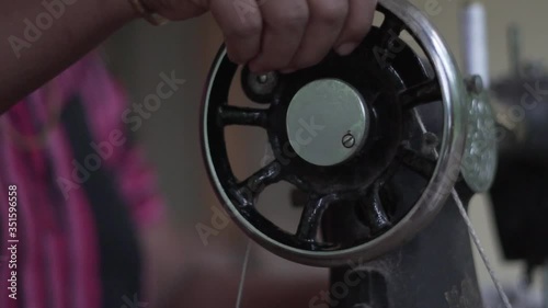 Close up of old sewing machine with women's hands on table slow motion