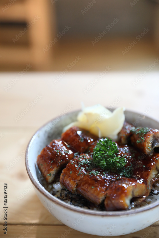 Japanese food unagi don , grilled eel on japanese rice on wood background Japanese food unagi don , grilled eel on japanese rice on wood background