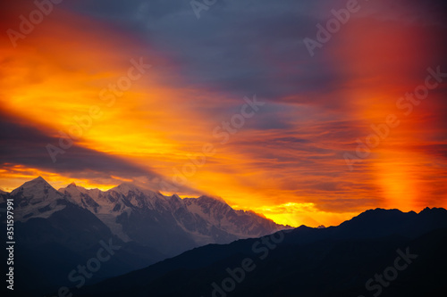 Fantastic brilliant sunrise with rays breaking through the clouds. Location place of  Upper Svaneti, Georgia country. © Leonid Tit