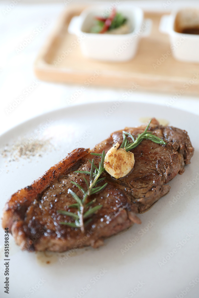 beef steak with salad on white table beef steak with salad on white table