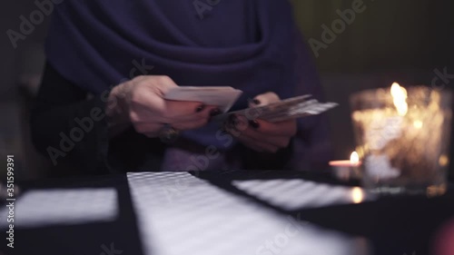 Unidentified woman fortuneteller with manicure and ring on hands