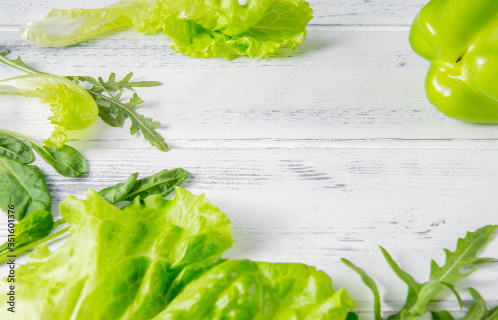 Obraz premium pepper, lettuce leaves, arugula , green spinach, herbs on a white