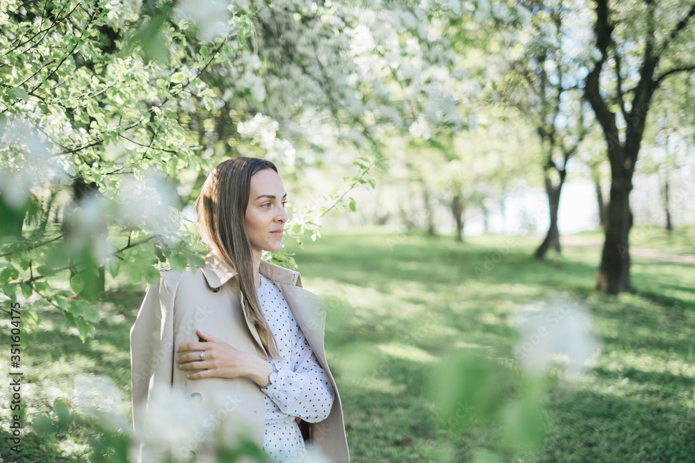 Beautiful young girl walks in the park, flowering trees, spring, sunny weather. Girl in a white dress. Blooming trees, beautiful nature, summer. Style, freedom, clothes Beautiful young girl walks in the park, flowering trees, spring, sunny weather. Girl in a white dress. Blooming trees, beautiful nature, summer. Style, freedom, clothes