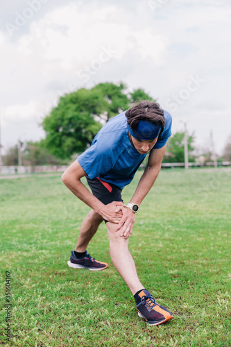 Athlete does warm-up before running at stadium © Denis