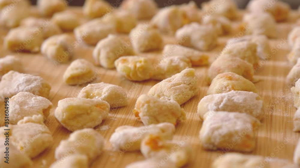 steady cam on chopping board full of gnocchi ready to be cooked steady cam on chopping board full of gnocchi ready to be cooked