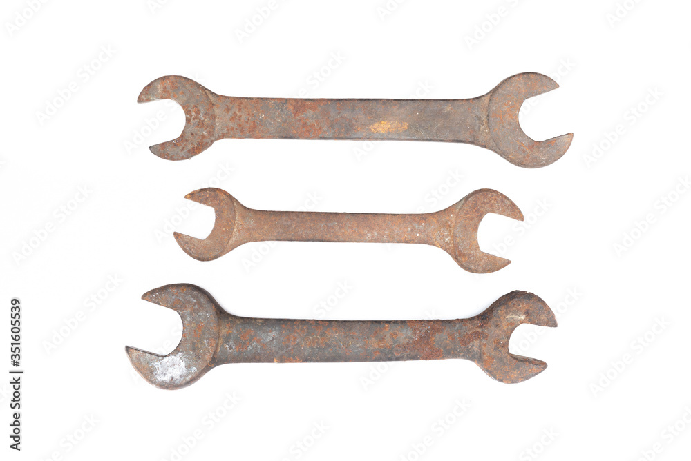 Old rusty wrench isolated on white background. 
