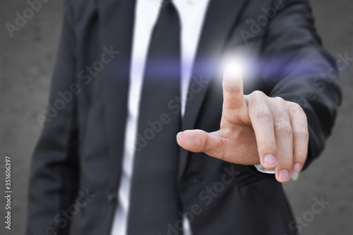 Businessman finger pressing an imaginary screen. Idea for business, technology, internet and networking.