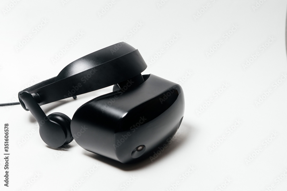 Original black stereoscopic 3d vr mask with headphones, with controller. Isolated on white background. Original black stereoscopic 3d vr mask with headphones, with controller. Isolated on white background.