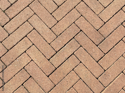 Full frame close up of red pavement bricks on symmetrical order as backbground