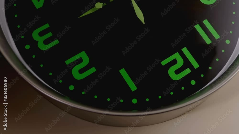 steady cam on reverse image of wall clock - clock hands turning fast