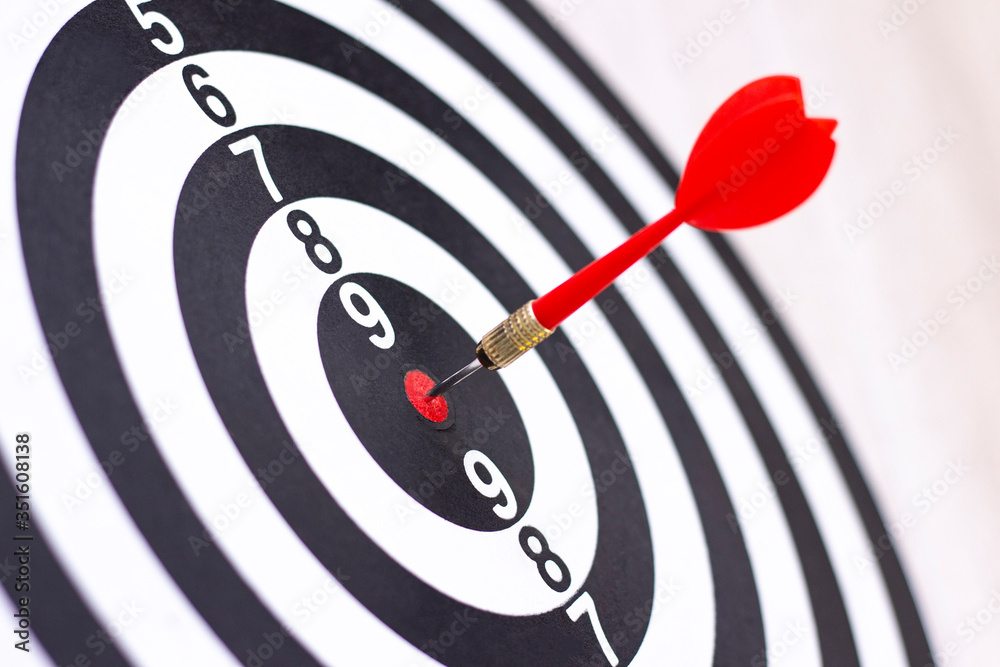 Dartboard with hit bullseye on white background, closeup. Bullseye is a business target. Target concept Dartboard with hit bullseye on white background, closeup. Bullseye is a business target. Target concept