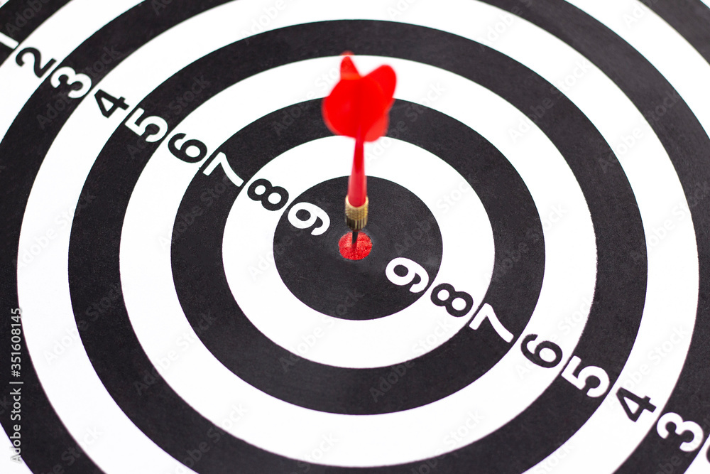 Dartboard with hit bullseye on white background, closeup. Bullseye is a business target. Target concept Dartboard with hit bullseye on white background, closeup. Bullseye is a business target. Target concept