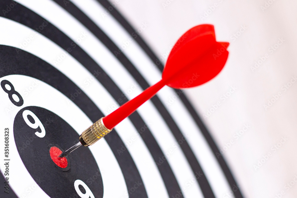 Dartboard with hit bullseye on white background, closeup. Bullseye is a business target. Target concept Dartboard with hit bullseye on white background, closeup. Bullseye is a business target. Target concept
