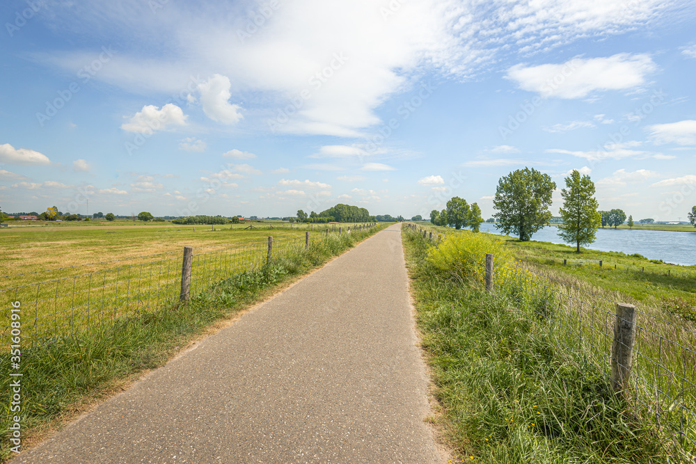 Endless path along a Dutch river in springtime Endless path along a Dutch river in springtime