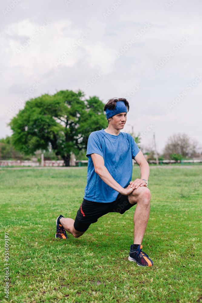 Athlete does warm-up before running at stadium Athlete does warm-up before running at stadium