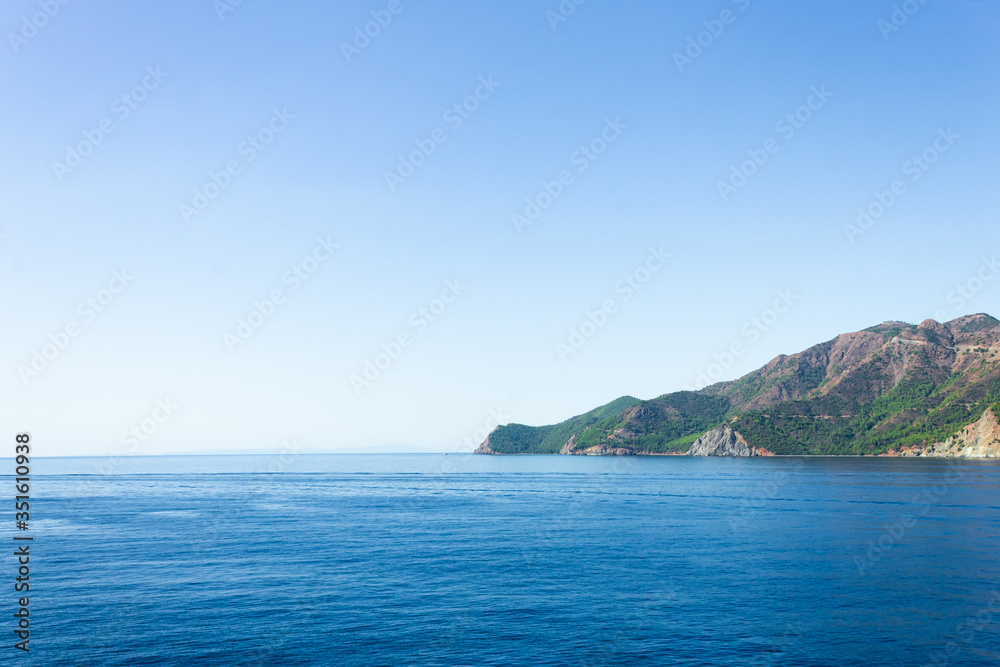 Seascape. Sea and mountains. Bright, colorful landscape. The nature of Turkey. Green mountains, blue sea.