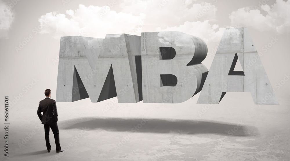 Rear view of a businessman standing in front of MBA abbreviation, modern technology concept Rear view of a businessman standing in front of MBA abbreviation, modern technology concept