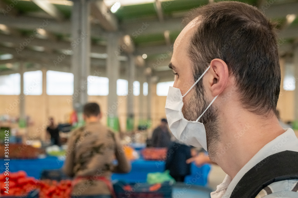 Man wearing a medical mask to prevent Covid-19 during grocery bazaar shopping Man wearing a medical mask to prevent Covid-19 during grocery bazaar shopping