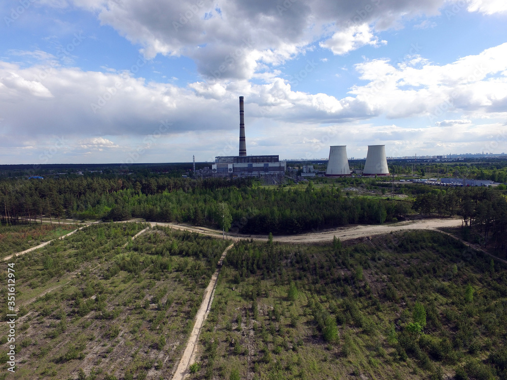 Chimney of power plant in the forest. Drone aerial view. Near Kiev,Ukraine