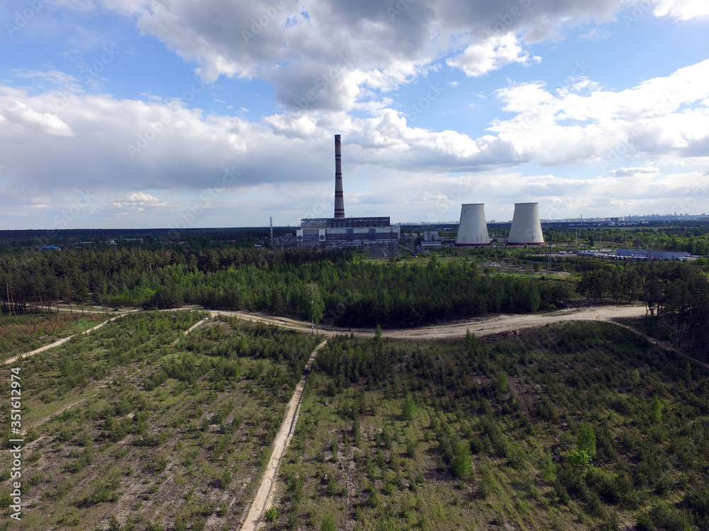 Chimney of power plant in the forest. Drone aerial view. Near Kiev,Ukraine Chimney of power plant in the forest. Drone aerial view. Near Kiev,Ukraine