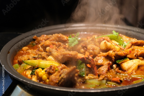 close up tasty bullfrog hot pot in darkness. Chinese food. Blur background 