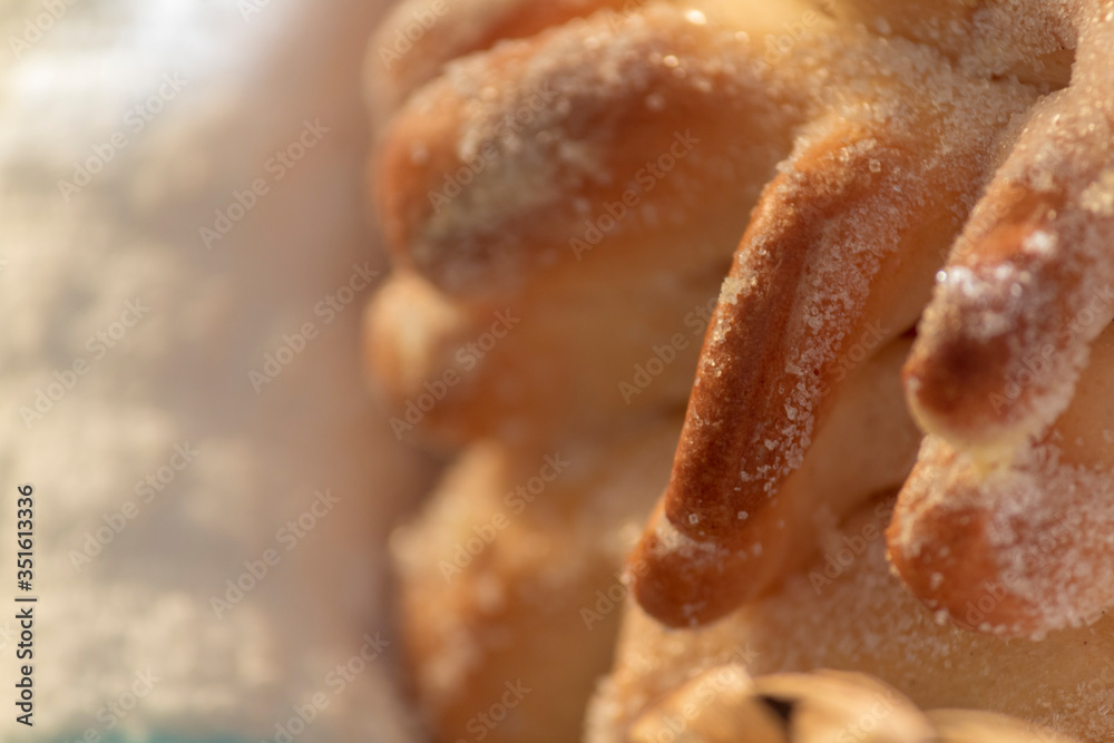 closeup on Mexican traditional Sweet Bread. Closeup of sweet sugary bread typically prepared for day of the dead celebration, a Mexican Halloween when offerings are made to ancestors. closeup on Mexican traditional Sweet Bread. Closeup of sweet sugary bread typically prepared for day of the dead celebration, a Mexican Halloween when offerings are made to ancestors.