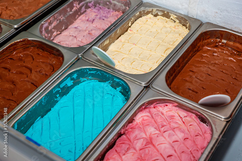 Different flavored colorful Ice cream serving counter with many