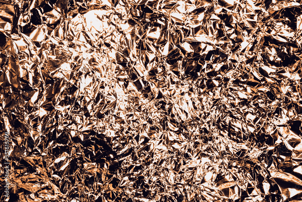 Golden crumpled foil as a background Golden crumpled foil as a background
