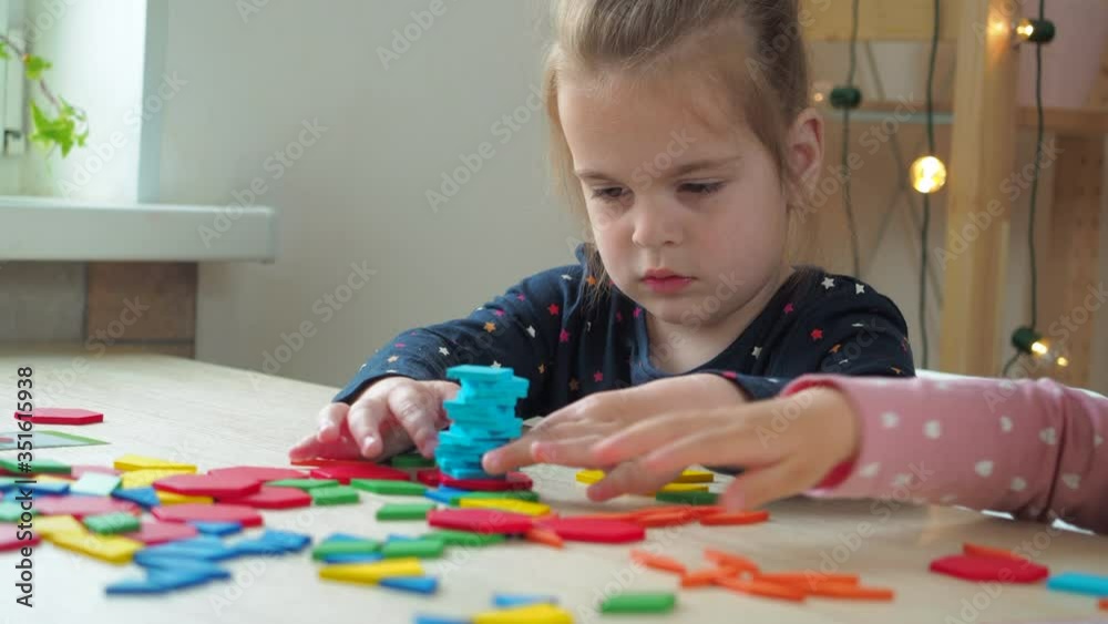 Cute little girls playing with constructor