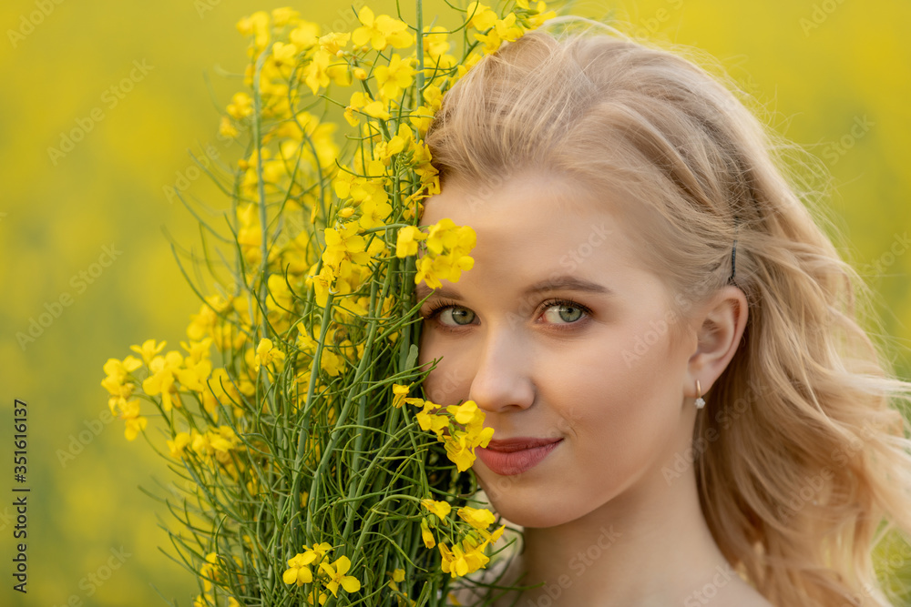 Close-up portrait of Beautiful blond young teen girl smell a bouquet of yellow flowers. Pleasure, nature, travel, vacation. Close-up portrait of Beautiful blond young teen girl smell a bouquet of yellow flowers. Pleasure, nature, travel, vacation.