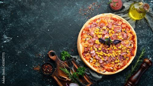 Pizza with sausage and corn. Top view. free space for your text. Rustic style.