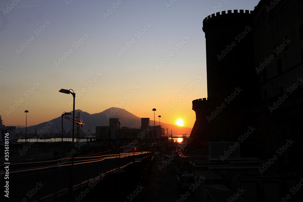 Naples, Italy. Vesuvio and Royal Castle nuovo or Maschio Angioino at dawn. Napoli, Campania, Italia