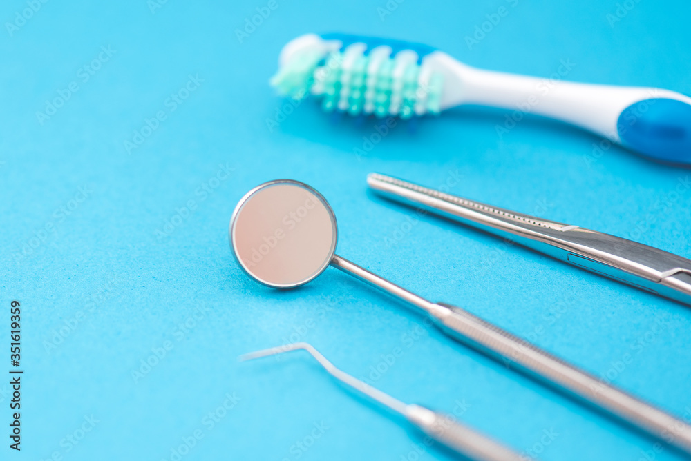 Professional dentist tools on blue background Professional dentist tools on blue background