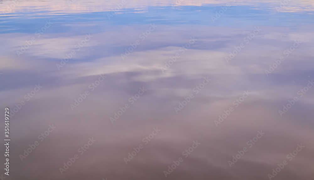 blurred colored background - the evening sky is reflected in the water blurred colored background - the evening sky is reflected in the water