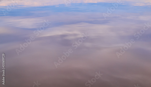 blurred colored background - the evening sky is reflected in the water