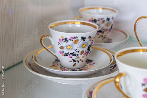 Ceramic cups from tea set close-up on a light background
