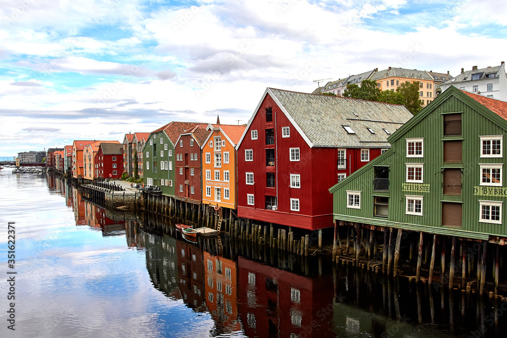 Bakklandet in Trondheim, Norway. This idyllic neighborhood on the east side of the Nidelva river features colorful old wooden buildings. Architecture, buildings, travel and photography concept.