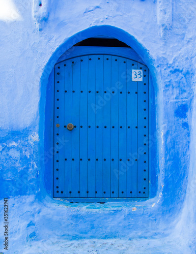 Blue door in Chefchaouen. Arabic arquitecture in Morocco © Andrs